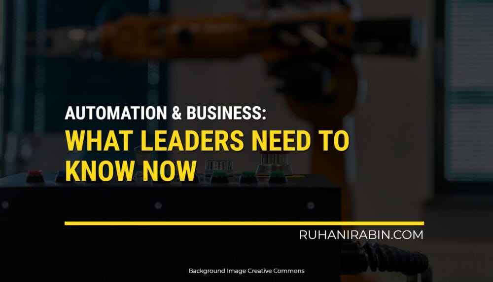 A picture shows the words "Automation & Business: What Leaders Need to Know Now" in bold yellow and white letters on a dark background with blurred machinery, highlighting the influence of automation on business. The website "ruhanirabin.com" is located in the bottom right corner, and credits mention that Creative Commons provided the background image.