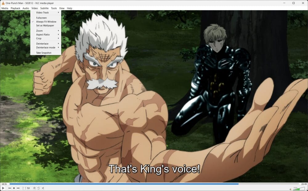 A strong, shirtless older man with white hair and a mustache is standing in a powerful pose in the forest. Behind him, someone wearing black armor is sitting against a tree. The subtitles on VLC Media Player say: Thats Kings voice!.