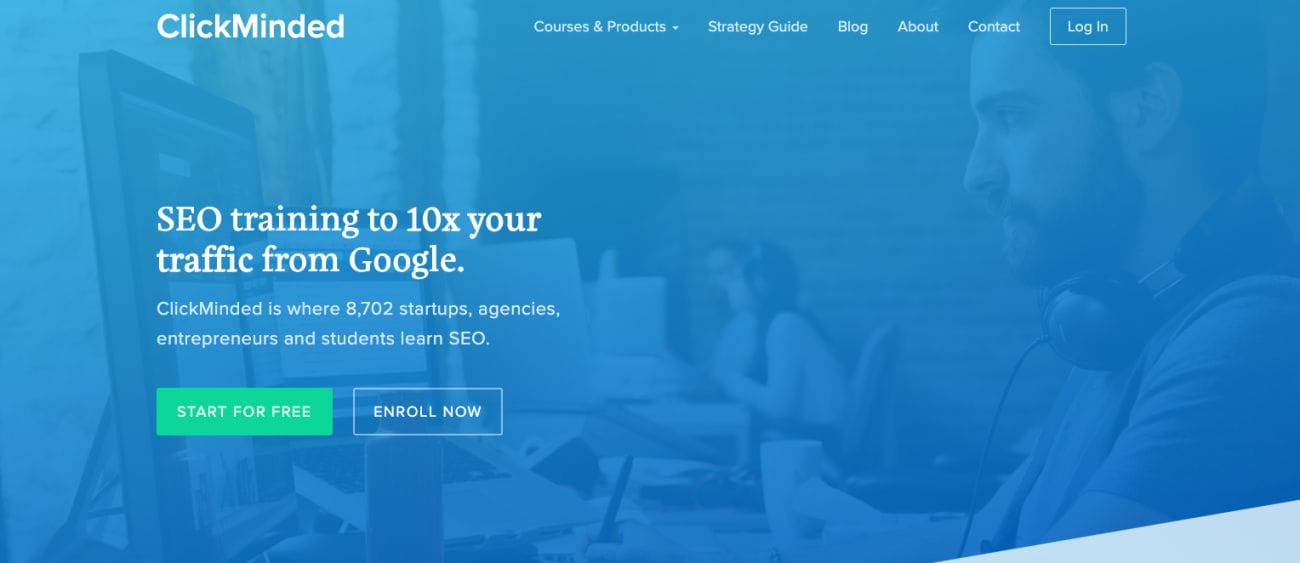 The ClickMinded website's main page offers training in SEO and digital marketing tips to help increase your traffic from Google. There's a button labeled "Start for Free" that lets you begin using the service at no cost. The site also mentions that 8,702 startups, agencies, entrepreneurs, and students are currently using their resources. In the background, there's an image of someone working on a computer.