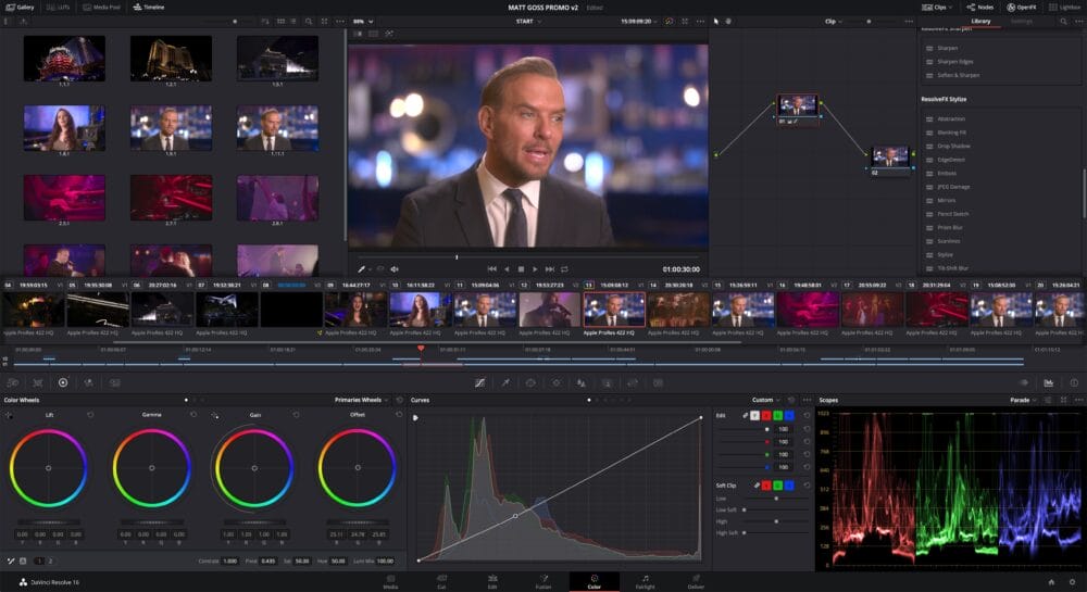 The DaVinci Resolve program is displayed on the screen. You can see a timeline full of video clips. Theres a window showing someone talking, and there are tools like color wheels and graphs for making detailed color tweaks to the videos.